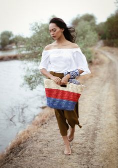 Our classic Sayan raffia bag is perfect for the sunnier month. Made from natural raffia straws in a warm tropical color combination. Carry it to the beach or for your next island getaways. Top Width: 18 inchesBottom width: 12 inchesHeight: 10.5 inchesDepth: 5 inchesMade by artisans in Bali Raffia Tote Bag, Woven Clutch, Tropical Colors, Raffia Bag, Basket Bag, Women Artisans, Independent Designers Fashion, Color Combination, Sweater Weather