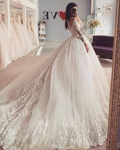 Look stunning on your wedding day in this Charming Long Sleeves Tulle Ball Gown Wedding Dress. Crafted from tulle with an A-line silhouette, this dress features a jewel neckline with detailed lace embellished long sleeves and a zipper back. The natural waistline and court train provide a perfect fit and flatter all body shapes. Perfect for any season. Gown Ideas, Long Sleeve Ball Gowns, A Wedding Dress, Wedding Dress Trends, Princess Wedding, Tulle Wedding, Popular Wedding, Online Wedding Dress, Tulle Wedding Dress