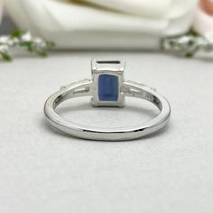 This beautiful ring is made from genuine 925 sterling silver with rhodium plating. Ring details- -The Main stone is an Emerald Cut 8mm by 6mm Lab Created Alexandrite Stone -Side stones are 4mm by 2mm Tapered Baguette simulated diamonds -Ring is casted in solid 925 sterling silver with rhodium plating (rose gold and yellow gold plated also available, please check the drop down menu for more options) -The Total face height of the ring measures 8mms and the band width measures 1.6mms -Each ring is Silver Sterling Silver Halo Ring For Promise, Silver Emerald Ring With Princess Cut And Prong Setting, Silver Princess Cut Emerald Ring With Prong Setting, Promise Opal Ring In Sterling Silver, Silver 14k White Gold Halo Ring For Promise, Silver Sapphire Ring In Princess Cut, Princess Cut Sapphire Ring In Sterling Silver, Sterling Silver Sapphire Ring With Center Stone For Promise, Wedding Sterling Silver Cluster Ring With Polished Finish