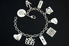 "A collection of silver plated aunt, love, and family themed charms have been dispersed around a shimmering silver plated bracelet chain in this handmade charm bracelet. This aunt themed charm bracelet is then completed with a lobster clasp and a 1/2 inch of chain at the end for adjustable sizing. Charms in this bracelet include a \"live laugh love\" charm, an ASL \"I love you\" charm, a \"family\" tab charm, an \"I love you\" letter charm, an \"aunt\" heart charm, \"A family's strength lies in Mother's Day Dangle Charm Bracelet, Personalized Silver Charm Bracelet For Gift, Personalized Silver Charm Bracelet For Anniversary, Personalized Silver Alloy Jewelry, Silver Charms For Friendship On Valentine's Day, Mother's Day Sterling Silver Charm Bracelet With Dangling Charms, Sterling Silver Charm Bracelet For Friendship On Mother's Day, Mother's Day Sterling Silver Friendship Charm Bracelet, Personalized Metal Charm Bracelet For Anniversary