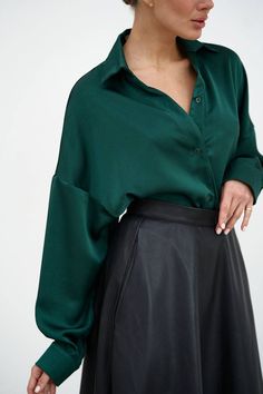 "Elegant green emerald satin shirt will accentuate your stylish look!  The straight collar, dropped shoulder line and asymmetrical hem of the shirt make it interesting, fastened with buttons.  The shirt can be worn in different variations, on the inside and out, tie the front edges of the shirt with a knot, the shirt goes well with any bottom from a classic style skirt to ripped jeans or leather shorts.  Suitable for casual everyday look, office and work, as well as for special occasions of graduation, birthday or holiday party.   DETAILS  - emerald green  - satin  - asymmetric hem  - straight collar  - dropped shoulder line  - buttoned     SIZES   This shirt is available in 2 sizes S-M and L-XL   Back length 29.52\"/ 75 cm  Dropped sleeve 17.7\"/ 45 cm  Shoulder 12.79\"/ 32.5 cm  S-M BUST Emerald Outfit Casual, Satin Collared Shirt Outfit, Green Satin Button Up Outfit, Emerald Green Style Outfit, Green Chemise Outfit, Emerald Green Clothes Casual, Emerald Shirt Outfit, Styling Green Shirt, Forest Green Shirt Outfit