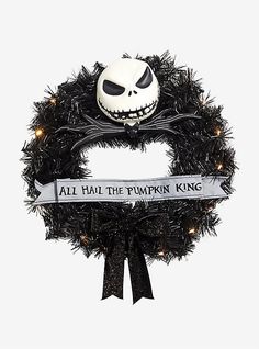 a wreath with a jack skellingy face on it and a ribbon that says, all hail the pumpkin king