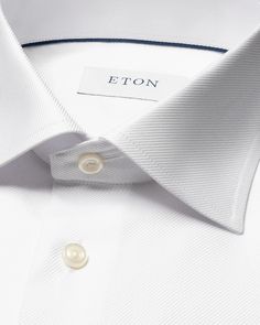 An exquisite classic dress shirt crafted from our textured twill fabric that is distinguished by its structured texture. This modern style statement features a robust and prominent texture while remaining silky soft, setting it apart as a remarkable alternative to traditional dress shirts. Crafted to perfection, it is exceptional for both business and elegant evening attire. Elegant Button-up Shirt With Concealed Placket, Elegant Shirt With Hidden Button Closure For Office Wear, Elegant Formal Tops With Concealed Placket, Elegant Semi-formal Tops With Concealed Placket, Elegant Tops With Concealed Placket For Semi-formal Events, Elegant Formal Tops With Hidden Button Closure, Elegant Business Casual Shirt With Button Closure, Elegant Business Casual Shirt, Tailored Button-up Elegant Shirt