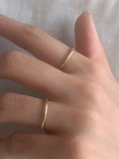 Editor's Notesbyweekend presents an essential round ring with a glossy surface. It is a simple yet, feminine item that stands out. - Plain round ring- Plain glossy surface- Made of silver 925- 18K gold plated- Sleek silhouette- Simple and basic style Measurements(in.)- Size: 3 / 5 / 7 / 9 / 11 / 13 / 15 / 17 / 19 Composition & Care- Material: Silver 925, 18K Gold Plating- Plated products may discolor over time due to their nature.- Please be careful that discoloratio Basic Rings Simple, Small Rings Simple Gold, Adjustable Timeless Midi Rings, Classic Open Band Midi Rings As Gift, Minimalist Open Band Jewelry With Shiny Finish, Adjustable Polished Finish Midi Rings With Round Band, Simple Polished Open Ring Jewelry, Classic Hypoallergenic Open Midi Rings, Minimalist Rounded Jewelry With Shiny Finish