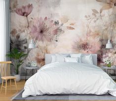 a large bed sitting in a bedroom next to a wall with flowers painted on it