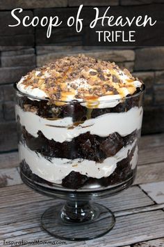 a cake sitting on top of a glass dish covered in frosting and toppings