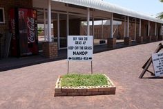 a sign in front of a building that says beware of glass keep off glass nakop