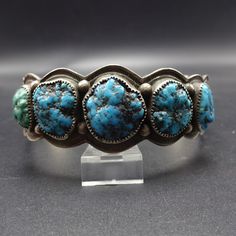 "VINTAGE NAVAJO BRACELET DESCRIPTION: This gorgeous old cuff features 5 specimens of deep blue natural polished turquoise. The gemstones are secure in micro-serrated bezel, on a foundation of heavy gauge, hand stamped vintage sterling silver. Don't overlook the elegant scalloped edges. This bracelet will be a cherished addition to your collection of fine vintage Native American jewelry. MEASUREMENTS: Interior of the cuff measures 6 1/4\" with an additional 1\" slightly adjustable gap. Total circ Jewelry Measurements, Vintage Native American Jewelry, Navajo Bracelet, Turquoise Bracelet Cuff, Turquoise Cuff, Vintage Navajo, Stone Work, Scalloped Edges, American Jewelry