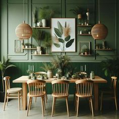 a dining room with green walls and plants on the shelves above it, along with wooden chairs