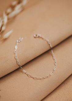 A delicate link chain that catches the light perfectly. Bracelet is adjustable from 6.5 - 7". Available in 14kt Gold Fill + Sterling Silver. Claire stacks it with our Pearl Bracelet. Cat pairs it with our Wander Cuff. Handmade in Eau Claire, WI. Our jewelry is handmade so each piece will be unique and may vary slightly from what is pictured. Dainty Metal Paperclip Bracelet With Rectangular Links, Dainty Solid Link Paperclip Bracelet, Dainty Sterling Silver Link Paperclip Bracelet, Dainty 14k Gold-filled Nickel-free Bracelet, Delicate 14k Gold-filled Pearl Bracelet, Copper Uses, Everyday Wear Jewelry, Adornment Jewelry, Jewelry Cleaner