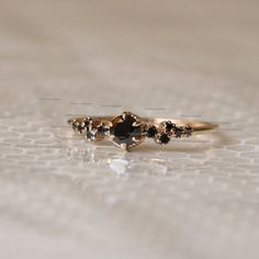 a gold ring with black stones on it