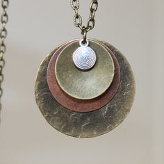 "Boho Necklace Pendant Bohemian Necklace pendant Boho Jewelry Necklace Pendant Mixed Metal Pendant Necklace Brass Necklace Bohemian Jewelry Finish : Antiqued Brass ( 32mm ) Copper Brass disc round Length : 19 inches for the antiqued brass chain and 1\"1/4 for the bigger metal Copper Disc Matching Earrings : https://www.etsy.com/listing/493613967/boho-earrings-copper-earrings-dangle?ref=shop_home_active_9 Necklace section : https://www.etsy.com/shop/NtikArtJewelry?section_id=16089749 To return to Adjustable Pendant Layered Necklace, Bohemian Brass Charm Necklace With Round Pendant, Hippie Metal Necklace For Gifts, Hippie Metal Necklace For Gift, Bohemian Oxidized Copper Jewelry, Hippie Style Metal Jewelry Gift, Nickel-free Brass Necklace In Brown, Bohemian Jewelry With Adjustable Chain And Medallion, Bohemian Jewelry With Medallion And Adjustable Chain