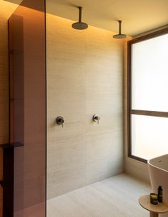 a bath room with a large window and a sink next to a stand up shower