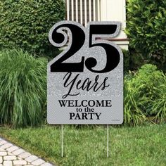 a sign that says 25 years welcome to the party in front of some grass and bushes