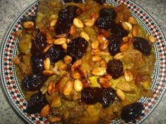 a bowl filled with nuts and raisins on top of a checkered plate