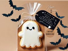 a cookie shaped like a ghost in a bag with a tag on it's side