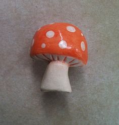 an orange mushroom with white dots on it