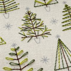 embroidered christmas trees on white fabric