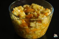 a glass bowl filled with food on top of a table