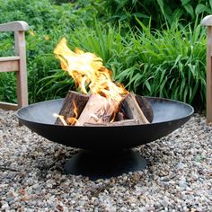 a fire pit sitting on top of a gravel field