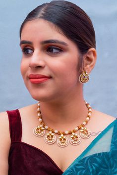 Description: Elevate your look with our Designer Gold Plated Kundan & Ruby Stone Necklace with Earrings. The intricate design and high-quality materials add a touch of elegance to any outfit. Perfect for special occasions or everyday wear, this set is a must-have for any fashion-forward individual. About: Eye-catching and unique jewelry that will set you apart. Gift this piece to a loved one, and see their face light up with joy. Best for gifting or for personal use, wear it to any occasion and Diwali Party Jewelry Sets, Festive Round Jewelry Sets With Matching Earrings, Festive Kundan Necklace With Matching Earrings, Meenakari Jewelry Sets For Parties, Diwali Jewelry Sets With Matching Earrings, Elegant Red Temple Necklace With Meenakari, Ruby Stone Necklace, Silver Pooja Items, Choker Designs