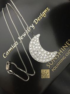 Luxury White Gold Crescent Necklace, Luxury Crescent White Gold Necklace, Luxury Crescent-shaped White Gold Jewelry, Silver Crescent Fine Jewelry Necklace, Silver Crescent Necklace In Fine Jewelry Style, Silver Crescent Necklace Fine Jewelry, Luxury Sterling Silver Moon Charm Jewelry, Luxury Sterling Silver Jewelry With Moon Charm, Crescent Necklace With Single Cut Diamonds