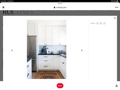 an image of a kitchen with white cabinets and black counter tops on the website page