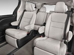 the interior of a car that is white and has black leather seats on both sides