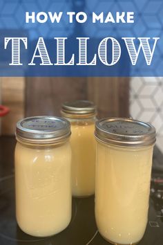 three jars filled with yellow liquid sitting on top of a table next to each other