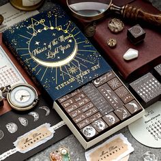 an assortment of chocolates and other items are on top of a table next to a pocket watch