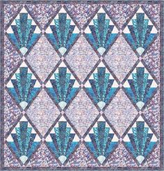 a blue and white quilt with an intricate design on the front, in different colors