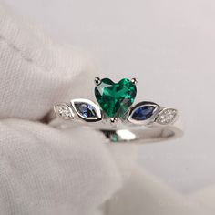 It is a graceful heart shaped lab emerald ring with CZ decorated as leave. ❉Ring Features Center Stone: Lab Emerald Center Stone Cut: Heart Cut 6*6mm Side Stone: Lab Sapphire, CZ Metal type: 925 Solid Sliver/14K White Gold/14K Rose Gold ❉Production time: All jewelry are handmade by me. Please allow 8~10 working days to make your piece after placed the order. ❉Made to Order Add engraving free of charge Different metal, gemstones or shapes available Personalization requests available Every piece o Emerald Ring White Gold, Leave Ring, Smaragd Ring, July Birthstone Ring, Ring Cluster, Engagement Ring Photos, Wedding Day Jewelry, Ring Heart, Heart Gemstone