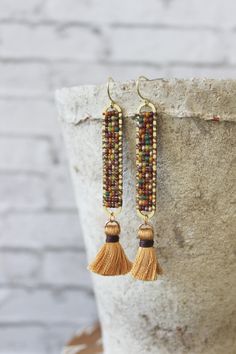 "earrings, dangle earrings, brass earrings, trendy jewelry, boho jewelry, gold jewelry, wire wrapped earrings, brass earrings These earrings are made with a brass oval hand stitched with autumn colors.  They measure 2.75\" long." Boho Jewelry Gold, Stitch Earrings, Earrings Patterns, Beaded Earring, Brick Stitch Earrings, Seed Bead Patterns, Earrings Trendy, Wrapped Earrings, Hippie Earrings