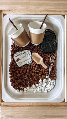 there is a tray with coffee and marshmallows on the bottom, along with other items