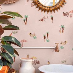 a bathroom with pink walls and palm trees on the wall