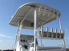 the back end of a white boat with metal railings