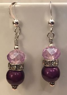 pair of earrings with purple beads and crystal stones