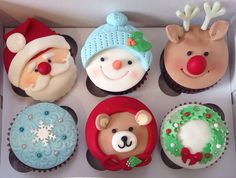 cupcakes decorated with christmas themed frosting in a box