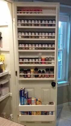 the pantry door is open to reveal an assortment of food items on display in it