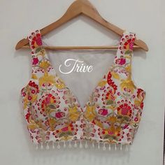 This Made to Order/Made to Measurement/Custom Made Indian Ethnic Blouse. - Fabric - Embroidered Georgette - Color -Red and White - Princess Cut - Rich Lined - Shoulder string with latkans - Sleeveless - Beads around waist - Extra margin and extra stitches included in the blouse - It can be customize in any color, design or size  MEAUREMENTS & CUSTOMIZATIONS This blouse can be purchased in your standard sizing and pattern. Please choose your Chest Size (measured in inches) from the drop-down box. Bohemian Embroidered Choli For Summer, Bohemian Choli For Summer Festivals, Bohemian Style Summer Festive Choli, Bohemian Summer Festive Choli, Traditional Summer Choli With Intricate Embroidery, Sleeveless Party Blouse With Intricate Embroidery, Sleeveless Choli With Intricate Embroidery For Festive, Sleeveless Choli With Intricate Embroidery For Festive Occasions, Embroidered Bohemian Choli For Summer