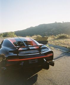 a black and red sports car on the road