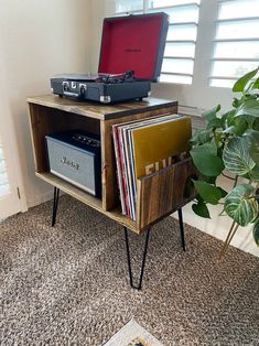 a record player sitting on top of a wooden cabinet