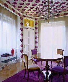 the dining room is decorated in purple and white