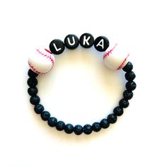 Sports themed name bracelets are great gifts for your favorite player or for sports themed bday party favors! Choose baseball, basketball or soccer beads, add a name, and we'll do the rest! The lava beads are 4mm. Please check all selections and spelling prior to check out. Our custom bracelets are made to order so all sales are final. The bracelets are beautifully packaged and ready to gift. Receipts are never included. Roll, don't pull. To avoid excess stretching please roll the bracelet on an Team-colored Sports Bracelets With Letter Beads, Team-colored Bracelets With Letter Beads For Sports, Team-colored Letter Beads Bracelets For Sports, Team Spirit Letter Beads Wristband For Game Day, Team Spirit Wristband With Letter Beads For Game Day, Team-colored Wristband For Game Day, Sporty Beaded Bracelets In Team Colors For Sports Events, Sporty Team-colored Beaded Bracelets For Sports Events, Sporty Beaded Bracelets With Letter Beads For Team Events