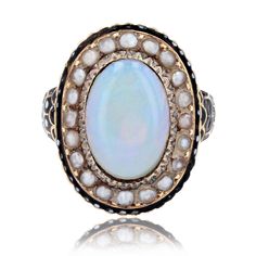 Ring in 18 karat yellow gold, owl hallmark. Beautiful and rare antique ring, it is decorated with an opal cabochon in the center of a chased decoration, surrounded by half fine pearls and a border of black and white enamel. The start of the ring is large, formed by small scales partially enameled black and white. Total weight of the opal : about 2.50 carats. Height : 20.5 mm approximately, width : 15.6 mm, thickness : 4.3 mm approximately, width of the ring at the base : 2 mm approximately. Weig Big Diamond, Etsy Gold Ring, Yellow Gold Ring, White Enamel, Antique Rings, Rare Antique, Yellow Gold Rings, Charm Pendant, Antique Jewelry