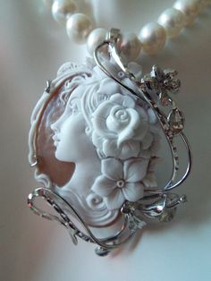 "This is a beautiful modern master hand carved sardonyx cameo by the artist, Carla. This is a very complex and intriguing piece and the design makes it an absolutely amazing piece of work. All the detail is exceptionally done to perfection! The right cameo is cameo is 48 mm mm (1.89\") and it is set into Italian silver with a 6 mm enhancer bail and a pin attachment. It comes packed in a black velvet box and certificate of authenticity for gift giving. Welcome to CASCO Cameos, LLC. CASCO Cameos i Elegant Gemstone Necklace For Collectors, Elegant Cameo Jewelry, Unique Cabochon Necklaces For Wedding, Elegant Collectible Pendant Necklaces, Elegant Collectible Pendant Necklace, Elegant Pendant Necklace For Collectors, Elegant Cameo Jewelry For Formal Occasions, Elegant Oval Pendant Necklace For Collectors, Exquisite Cameo Jewelry For Formal Occasions