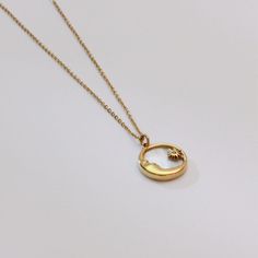 Capture the serene beauty of the night sky with our elegant gold crescent moon pendant, featuring a stunning shell inlay that shimmers with ethereal colors. This minimalist necklace is a subtle yet striking accessory, perfect for those who appreciate the delicate balance of modern style and timeless symbolism.   Enhance your jewelry collection with this beautifully crafted crescent moon necklace, a symbol of mystery and elegance. Care Instructions   Avoid exposure to harsh chemicals and store th Celestial Round Charm Necklace With Clavicle Chain, Moon Shaped Celestial Necklace With Sun And Moon Design, Celestial Moon-shaped Necklace With Sun And Moon Design, Celestial Moon Necklace With Sun And Moon Design, Gold Crescent Celestial Necklace, Celestial Crescent Gold Necklace, Celestial Sun And Moon Round Necklaces, Celestial Sun And Moon Round Necklace, Elegant Yellow Gold Necklaces With Sun And Moon Design