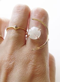 This beautiful white moonstone gemstone features a subtle glow. Set in 14k gold fill, this ring is a perfect for everyday wear or as a statement piece. Featuring a stunning crescent moon shape design. Ring is made in size 6 and is adjustable due to the style of the ring. It can be made larger upon request before purchase. Gemstone is approx. 10mm in diameter. This piece is a very limited edition. Please note: Due to the nature of the moonstones, each of these stones can vary from the original. M Adjustable Crescent Moonstone Ring, Adjustable Ethereal White Jewelry, White Moonstone Celestial Ring In Moon Shape, Celestial White Moonstone Ring In Moon Shape, White Moonstone Moon Ring, Adjustable White Jewelry With Sun And Moon Design, Minimalist Moonstone Moon-shaped Ring, Modern Adjustable Moonstone Gemstone Ring, Modern Adjustable Moonstone Ring