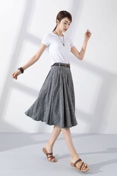 "Add some vintage-inspired charm to your wardrobe with our gray linen pleated swing circle skirt. Made from high-quality materials, it's both soft and durable, and perfect for keeping you looking and feeling your best. The unique pleated design adds a touch of classic elegance, while the swing circle cut gives the skirt a playful, feminine flair. Whether you're dressing up for a special occasion or keeping it casual for a day out with friends, this skirt is the perfect choice. Order now and add Gray Relaxed Skirt For Spring, Relaxed Gray Skirt For Spring, Gray Cotton Skirt For Spring, Pleated Flowy Linen Skirt, Spring Relaxed Gray Skirt, Chic Knee-length Flowy Pleated Skirt, Gray Midi Skirt For Summer, Summer Gray Lined Skirt, Casual Gray Flowy Skirt