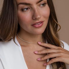 Give the gift of sparkle this holiday season with our Diamond Tennis Choker Necklace. Featuring dazzling diamond gemstones on a delicate chain, this versatile piece adds elegance to any look—from casual outings to glamorous date nights. A perfect Christmas gift to make someone shine. SKU: RR-NR152 Product Details Finish/Material: 18K Gold Over Brass ∙ Rhodium Over Brass, CZ Diamond Gemstones Featuring a Dainty ~2mm CZ Diamond Tennis Choker Necklace, available in 2 lengths: 14 Inches + 2 Inch Ext Classic Rose Gold Tennis Necklace Gift, Dazzling Single Strand Round Cut Jewelry, Rose Gold Diamond Cut Tennis Necklace, Dazzling Single Strand Diamond Jewelry, Diamond White Solitaire Single Strand Necklace, Diamond Choker With Adjustable Chain, Diamond Choker Necklace With Adjustable Chain, Minimalist Tennis Necklace For Anniversary, White Gold Clavicle Chain Tennis Necklace Gift